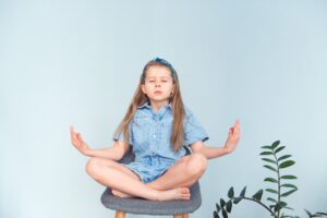 Cute girl meditating zen pose